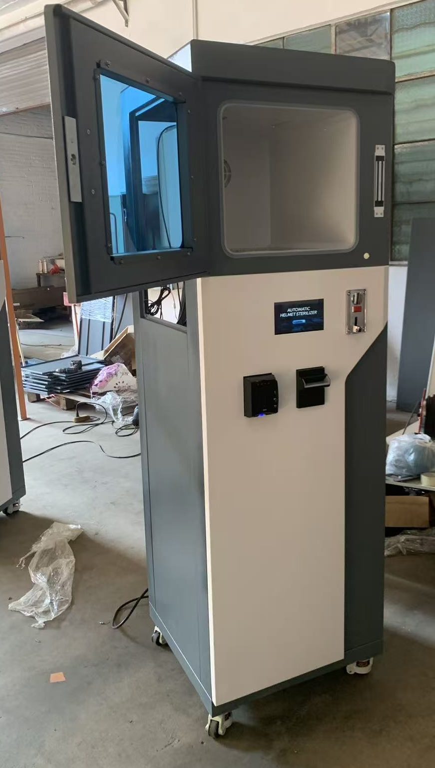 Max03 with the chamber door open, showing the stainless chamber and payment devices