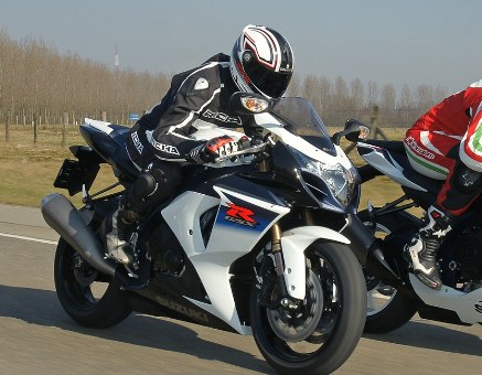 Motorcycle riders in full gear on a circuit